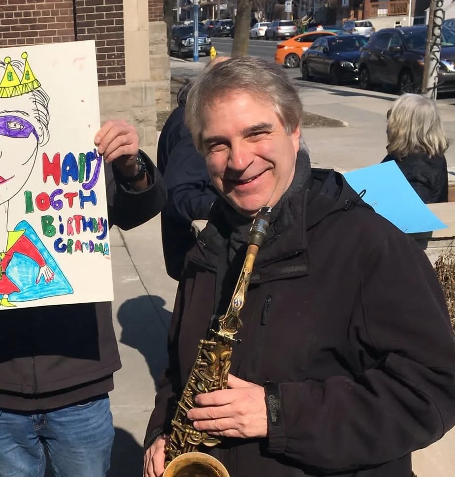 Lenny Graf playing saxophone at a senior's birthday celebration